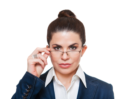 Beautiful, serious  businesswoman  wearing glasses and a formal office suit, looking at camera.の写真素材