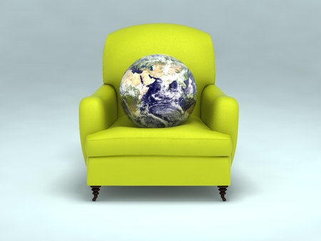 one earth sphere on green leather sofa.の写真素材