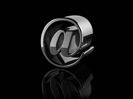 black metallic at sign on black background.の写真素材