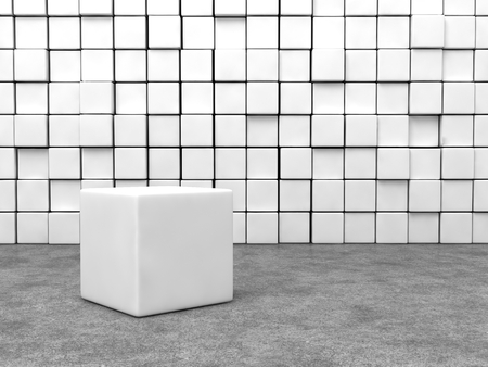 white cube in front of cubes wall and cement floor.の写真素材