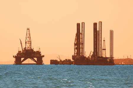 Oil rig during sunset in Baku, Azerbaijan in Caspian Seaの写真素材
