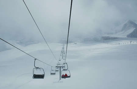 Cables of skilift during blizzardの写真素材