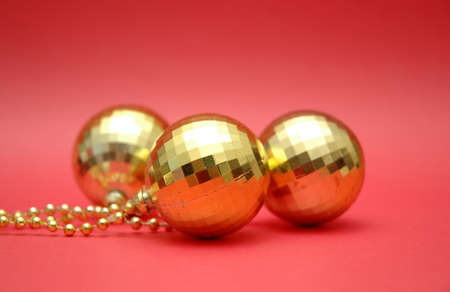 three golden balls on the red backgroundの写真素材