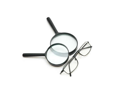 Magnifying glasses and reading glasses isolated on whiteの写真素材