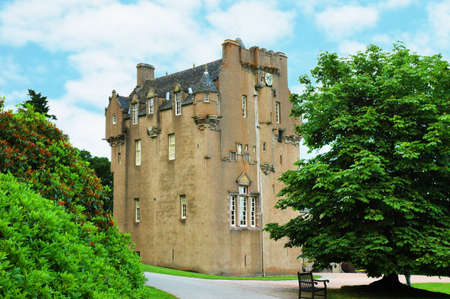 Scottish castle between the trees in summer dayの写真素材