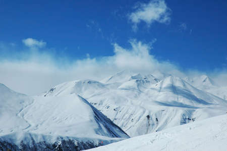 Scenery with mountains covered with the snow