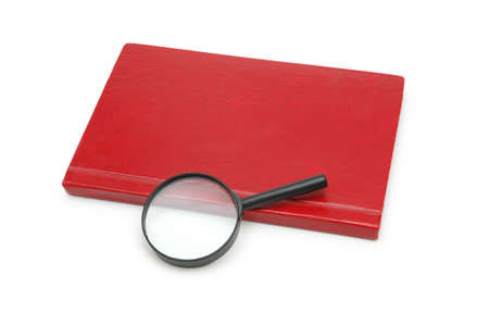 Magnifying glass over the red book isolated on whiteの写真素材