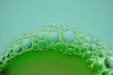 Foam bubbles on blue and green backgroundの写真素材