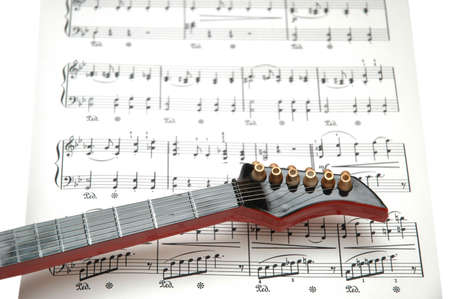 Rock guitar over the sheet of printed musicの写真素材