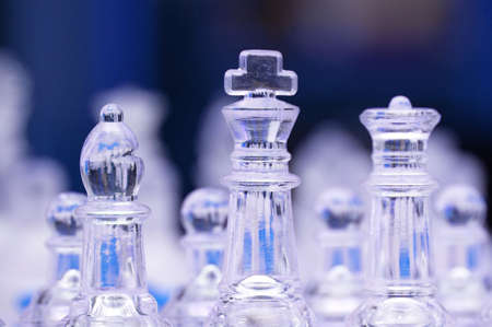 Glass chess figures against blurry backgroundの写真素材