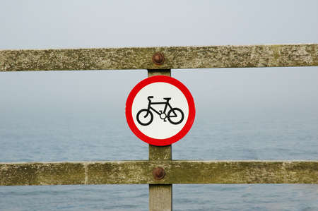 Red "Bicycle" sign on the wooden railsの写真素材