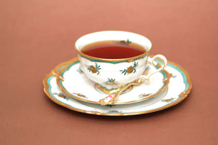 Cup of black tea, saucer  and spoonの写真素材