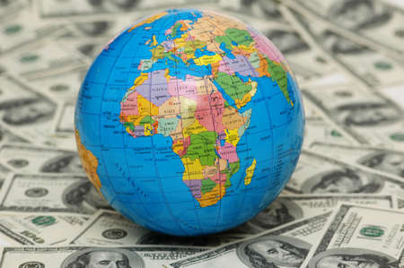 Globe isolated  on the background of dollar bank notesの写真素材