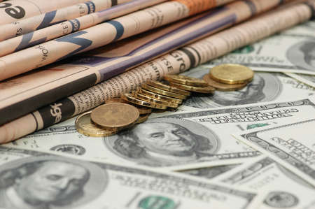 Business newspapers, coins and  dollar bank notesの写真素材