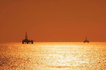 Two offshore oil rigs during sunset  in Caspian seaの写真素材