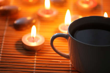 Cup of tea and aromatic candles  in the darkの写真素材