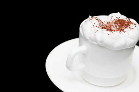 Cup of coffee with cream isolated  on blackの写真素材