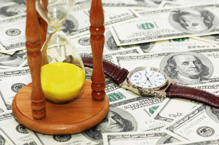 Concept Time is money  with hourglass and watch