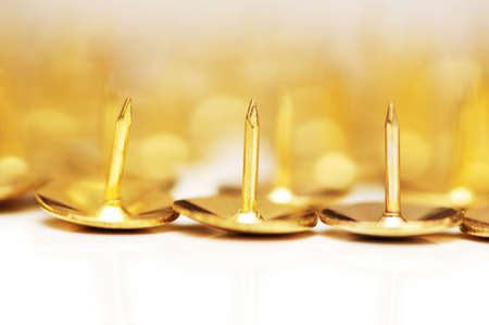 Golden pins isolated on the white backgroundの写真素材
