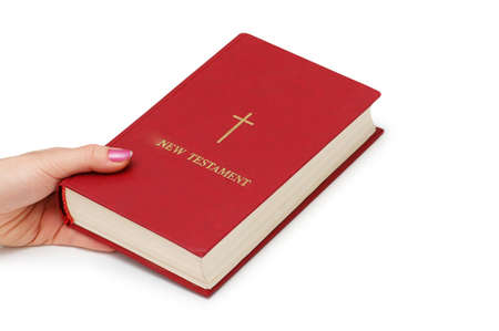 Hand holding  "New Testament" book isolated on whiteの写真素材
