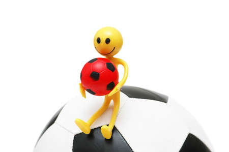 Smilie sitting on the football isolated on  whiteの写真素材