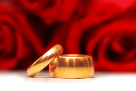 Wedding rings and roses  at the backgroundの写真素材