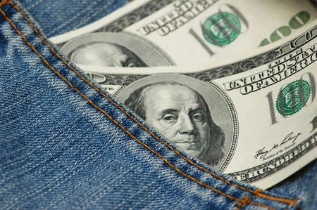 Hundred dollar bank note in the jeans pocket