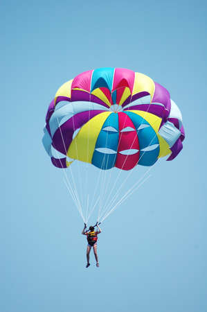 Multi coloured parachute over the blue skyの写真素材