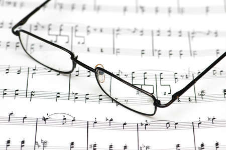 Reading glasses over the music sheetsの写真素材