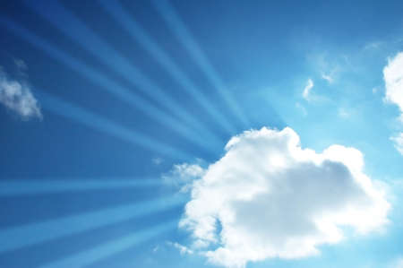 Blue sky and sun beams through the cloud