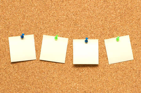 Yellow post it notes on the corkboardの写真素材