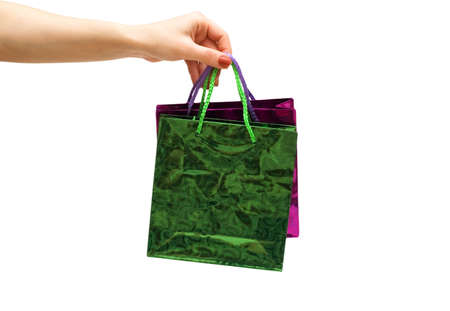Hand holding gift bag isolated on whiteの写真素材