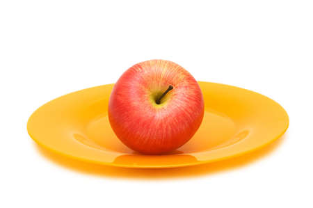 Red apple and plate isolated on the whiteの写真素材