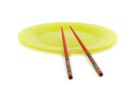Yellow plate and chopsticks isolated on the whiteの写真素材