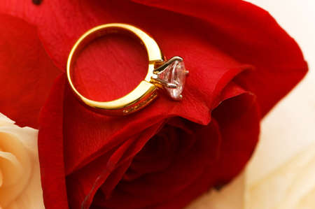 Wedding concept- golden ring over red roseの写真素材