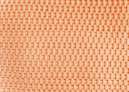 Background made of woven reddish plastic stripes