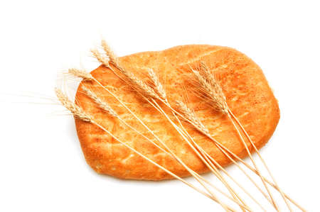 Bread and wheat ears isolated on white
