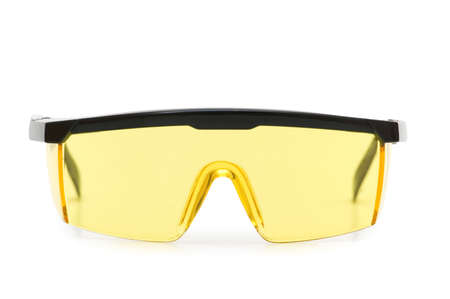 Yellow safety glasses isolated on the white backgroundの写真素材