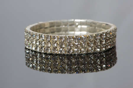 Diamond bracelet with many stones on reflective backgroundの写真素材