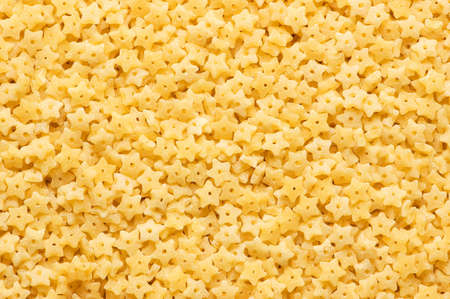 Background made of star shaped pasta piecesの写真素材