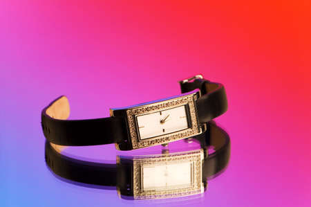 Hand watch against blue and red backgroundの写真素材