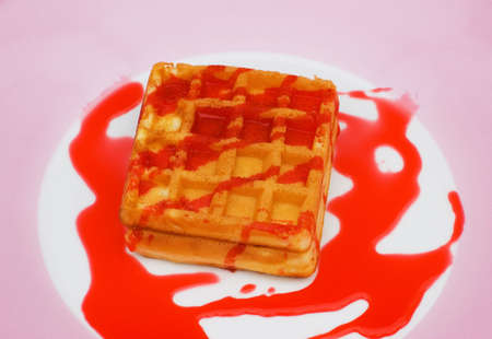 Belgian wafers with strawberry syrup on white