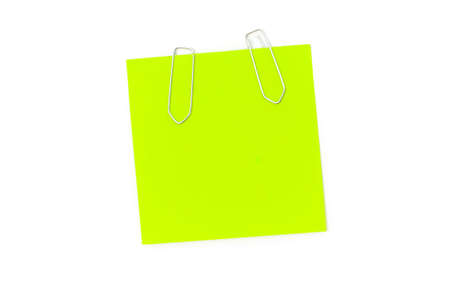 Green reminder note with paperclips isolated on the whiteの写真素材