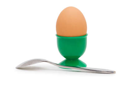 Brown egg in holder isolated on whiteの写真素材