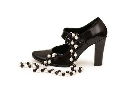 Shoes and necklace  isolated on the whiteの写真素材