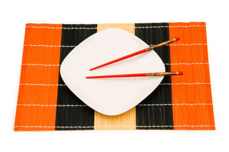 White plate with chopsticks isolated on whiteの写真素材