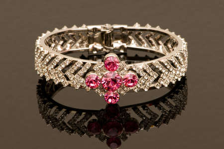 Bracelet with red stones on reflective backgroundの写真素材