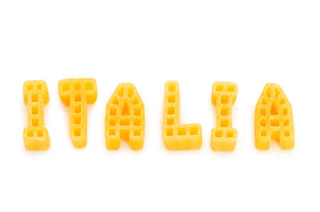 Word Italia written with pasta shapes on whiteの写真素材