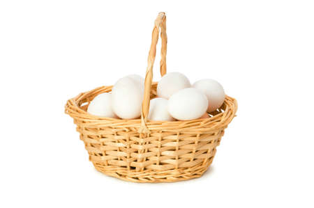 Basket full of eggs isolated on whiteの写真素材