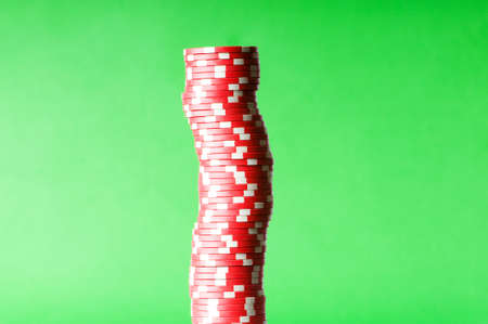 Stack of red casino chips against green backgroundの写真素材